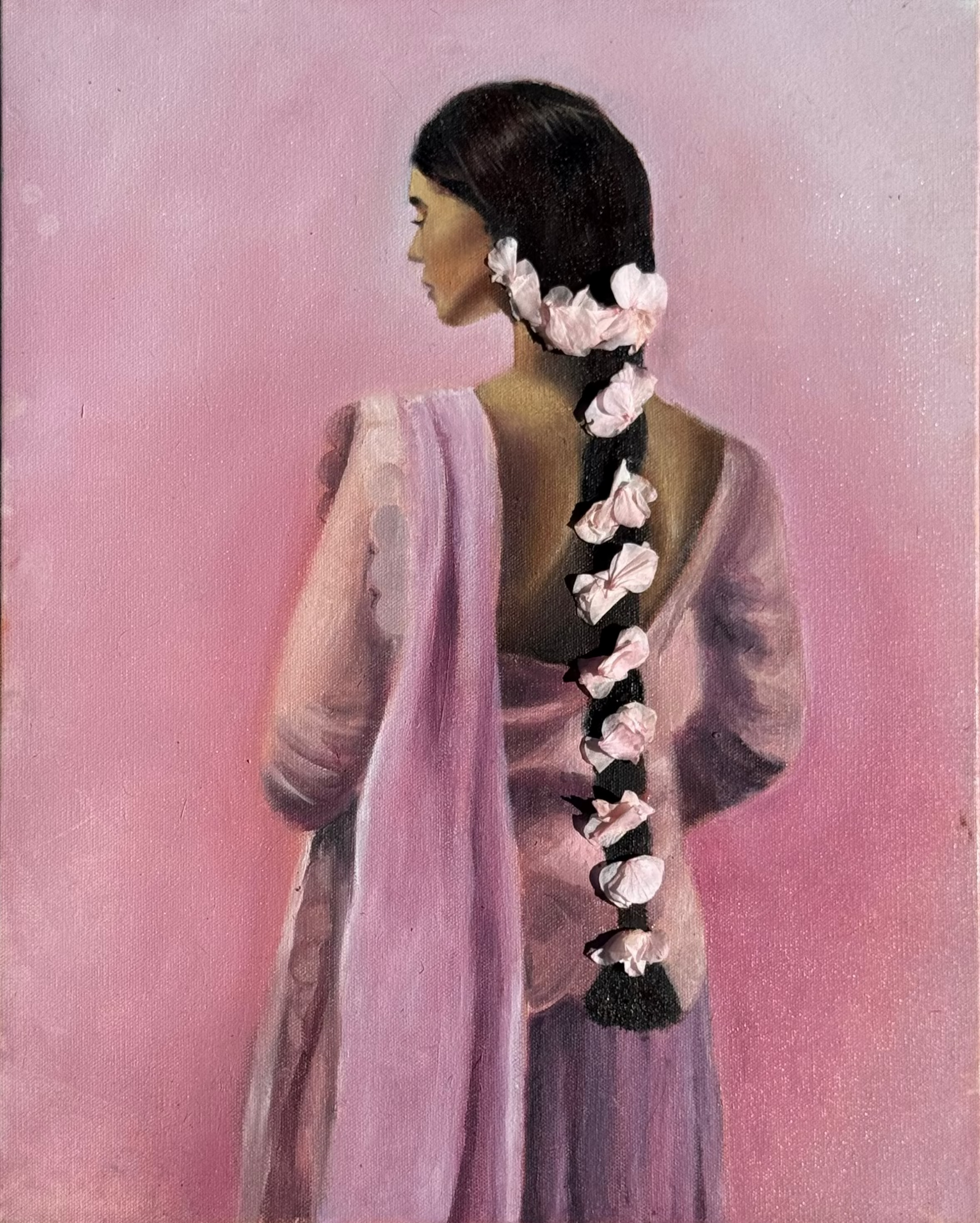 Artistic depiction of a desi woman with a floral braid against a pink background